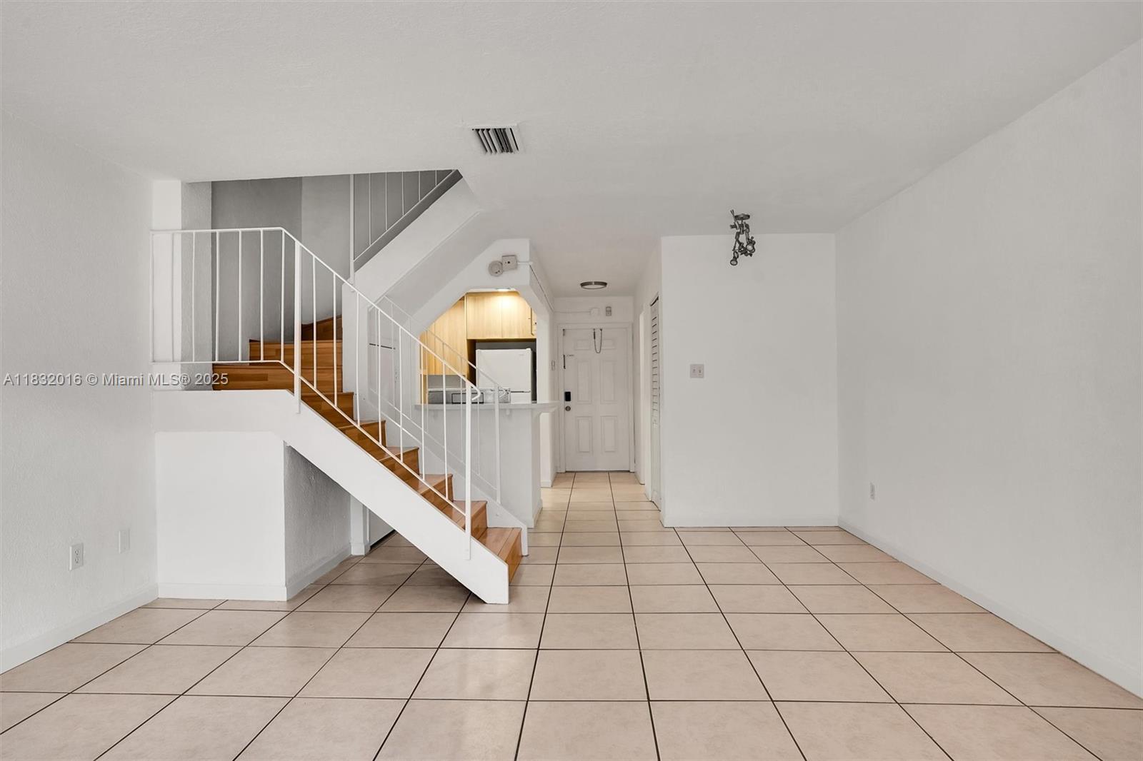 8650 Southwest 67th Avenue, Unit 1025 Pinecrest, FL 33156 - Photo 13 of 26 a view of an entryway with staircase