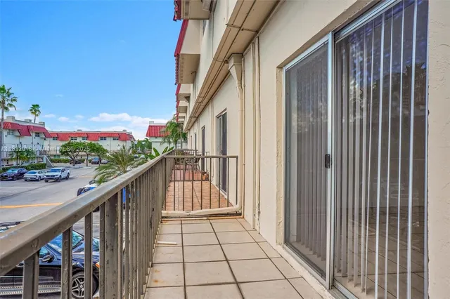 a view of a balcony with wooden floor and stairs
