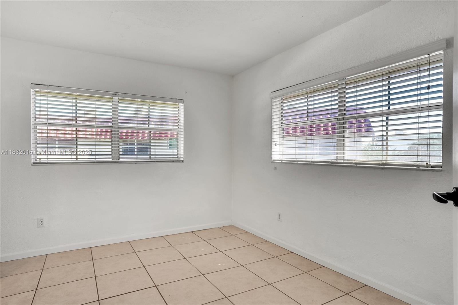 8650 Southwest 67th Avenue, Unit 1025 Pinecrest, FL 33156 - Photo 17 of 26 a view of an empty room with a window
