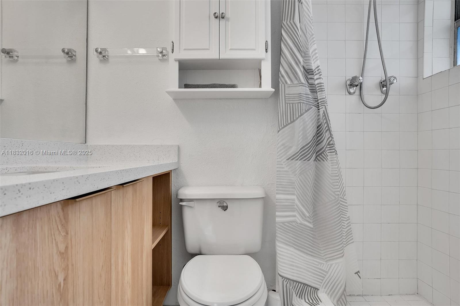 8650 Southwest 67th Avenue, Unit 1025 Pinecrest, FL 33156 - Photo 23 of 26 a bathroom with a toilet sink and shower