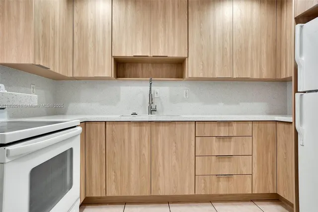 a kitchen with a sink cabinets and a microwave oven