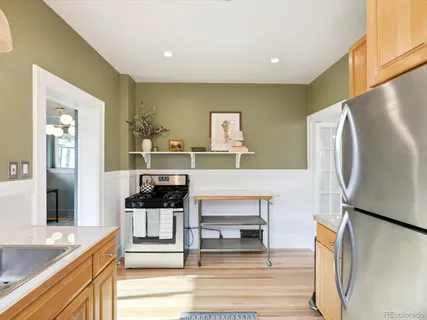 a kitchen with stainless steel appliances a refrigerator and a stove top oven