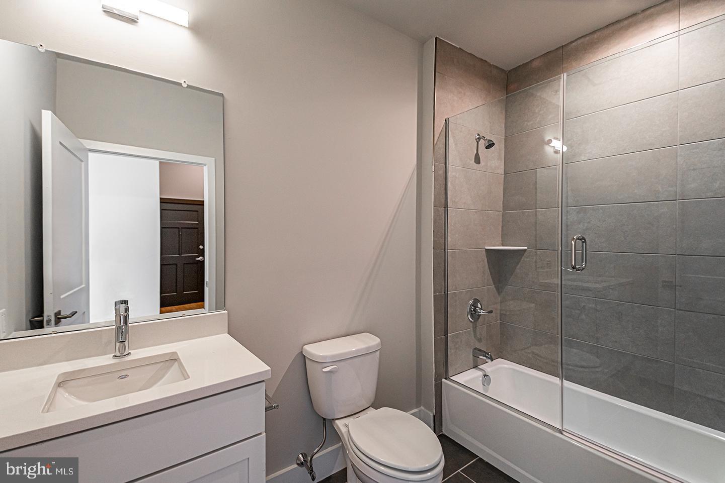 1300 South 19th Street, Unit 316 Philadelphia, PA 19146 - Photo 8 of 19 a bathroom with a sink a toilet and shower