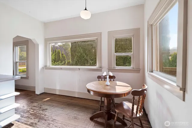 a view of a room that has a window and furniture