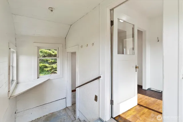 a view of an entryway with wooden floor and windows