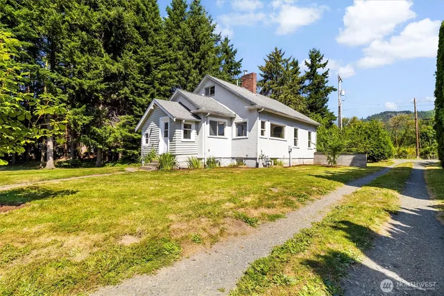 a view of a house with pool and a yard
