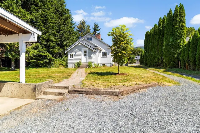 a view of a house with swimming pool and porch with furniture
