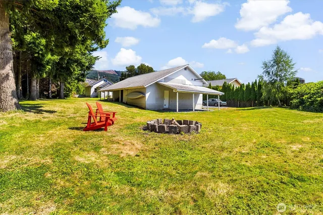 a view of a house with swimming pool and sitting area