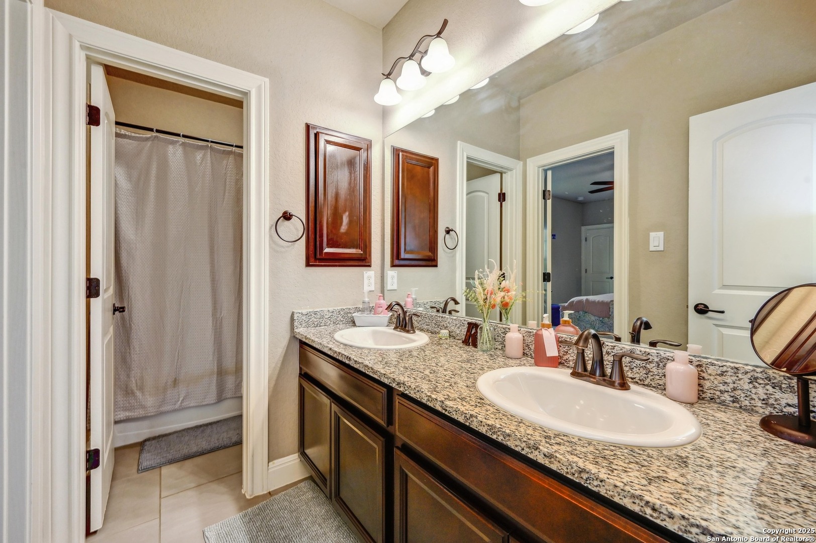 101 La Rosa Drive Blanco, TX 78606 - Photo 19 of 31 a bathroom with a granite countertop double vanity sink and a mirror