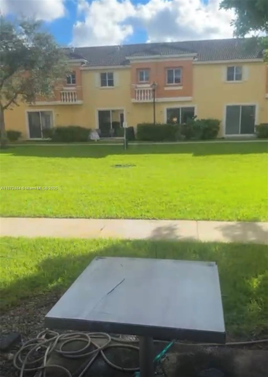 8936 Southwest 18th Street, Unit 8936 Miramar, FL 33025 - Photo 2 of 10 a view of swimming pool with lawn chairs and plants