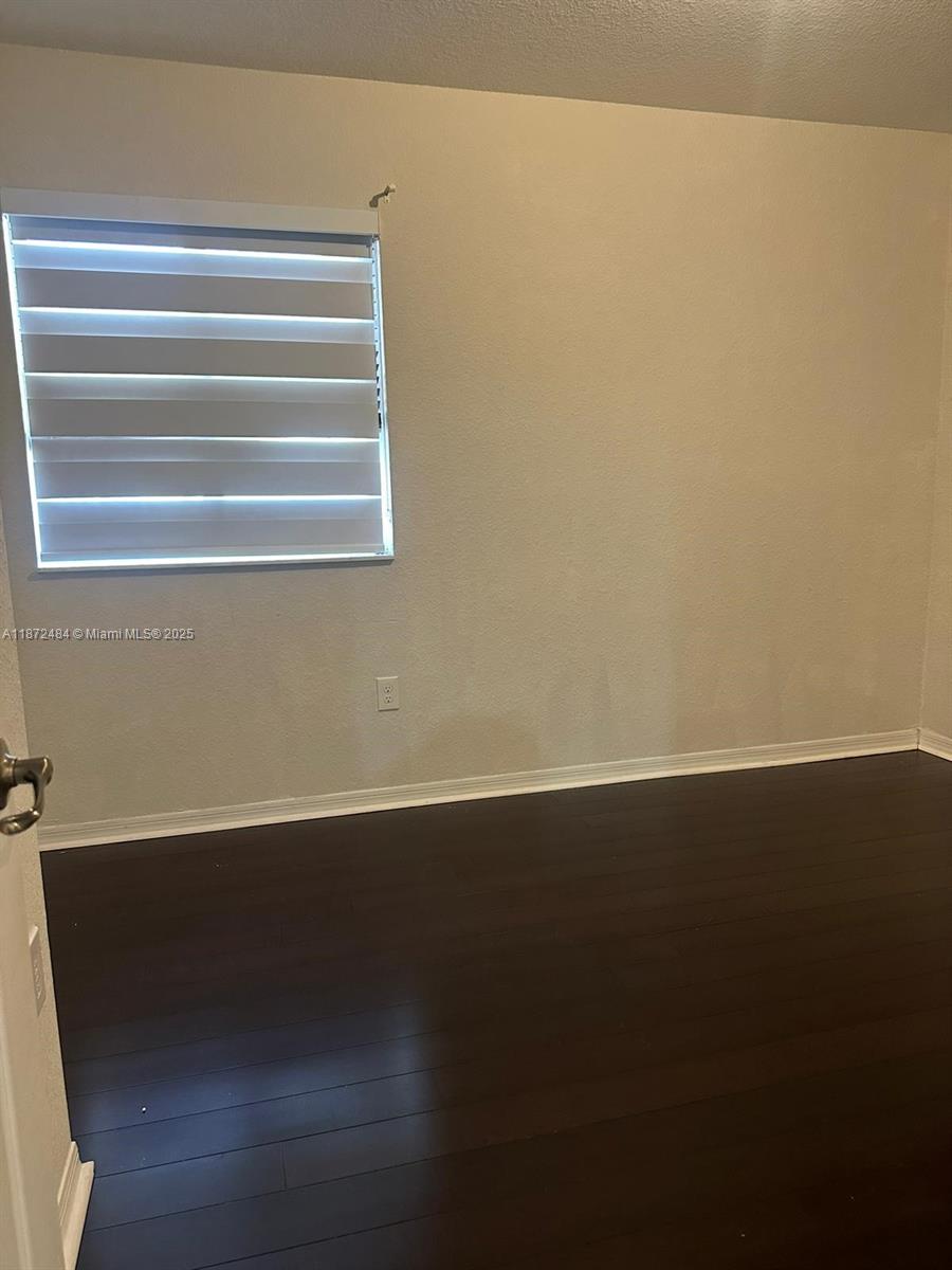 8936 Southwest 18th Street, Unit 8936 Miramar, FL 33025 - Photo 7 of 10 a view of a room with wooden floor