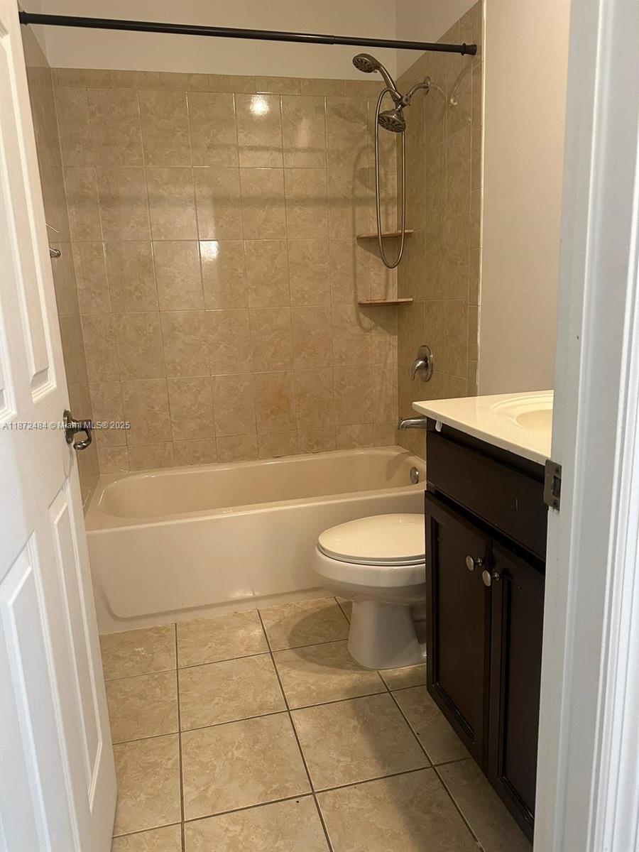 8936 Southwest 18th Street, Unit 8936 Miramar, FL 33025 - Photo 9 of 10 a bathroom with a sink a toilet and shower