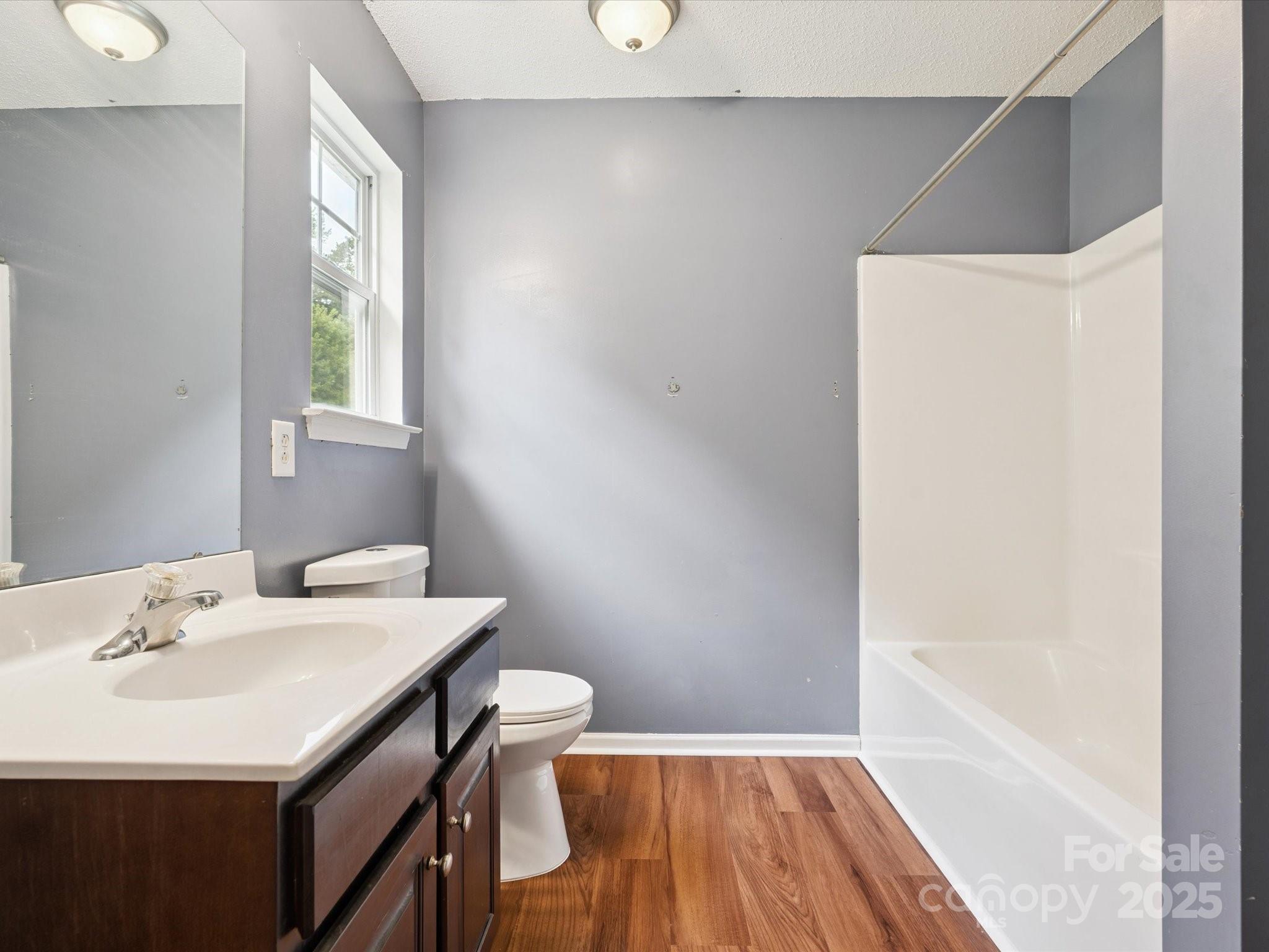 829 Raindrops Road Gastonia, NC 28054 - Photo 11 of 16 a bathroom with a sink a toilet and a bathtub