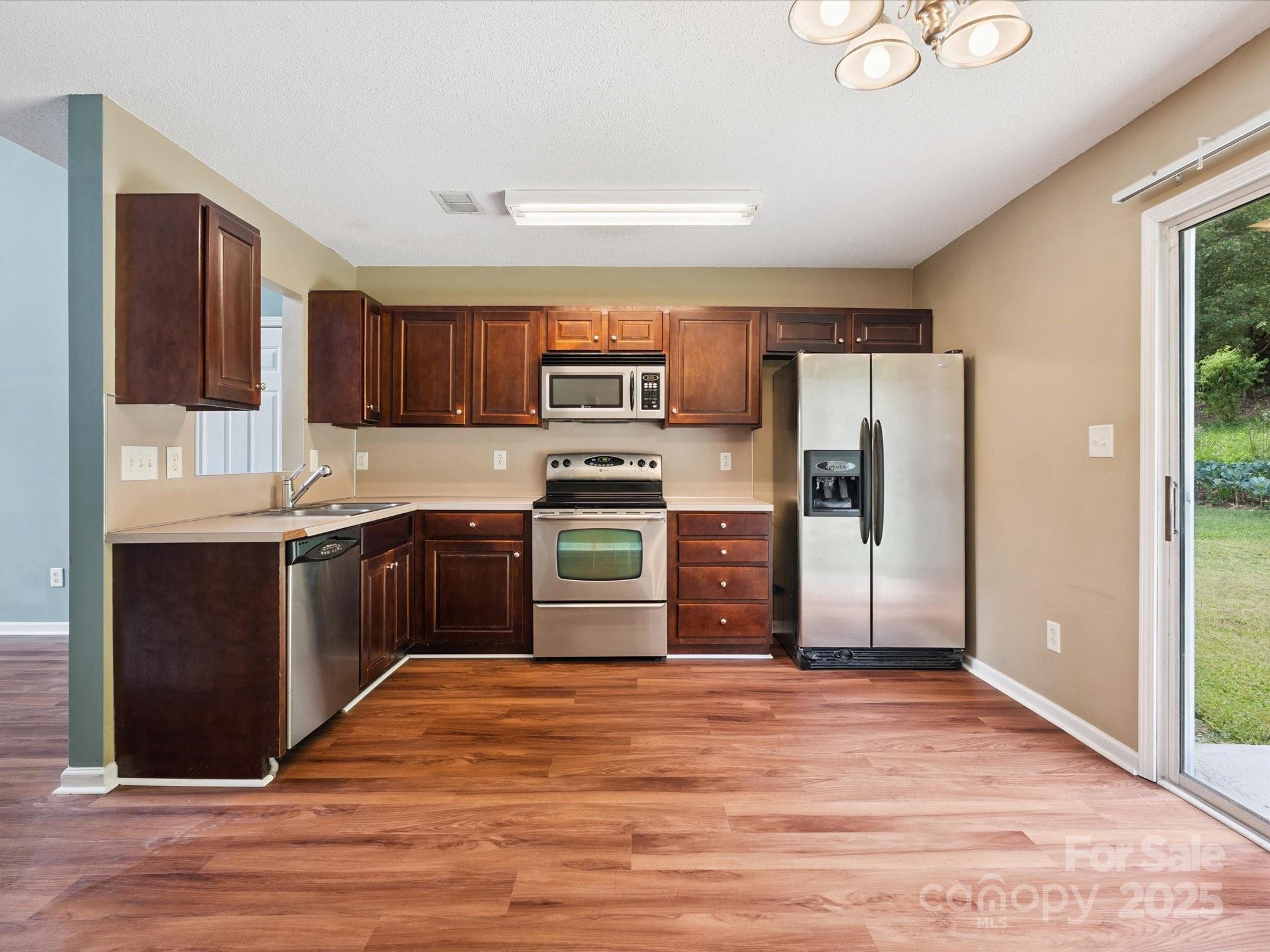 829 Raindrops Road Gastonia, NC 28054 - Photo 2 of 16 a kitchen with stainless steel appliances granite countertop a refrigerator and a stove top oven