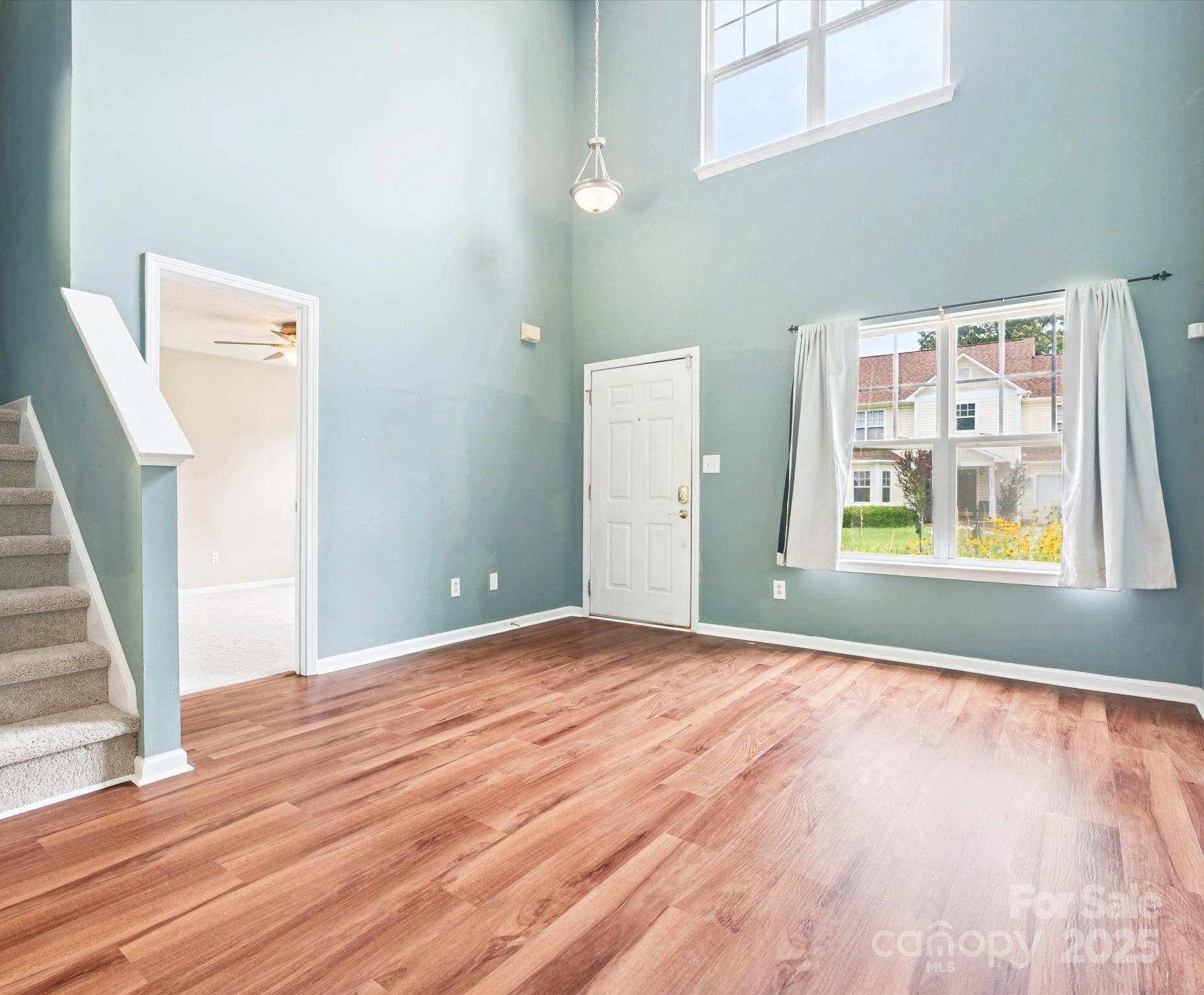 829 Raindrops Road Gastonia, NC 28054 - Photo 4 of 16 a view of an empty room with window and wooden floor