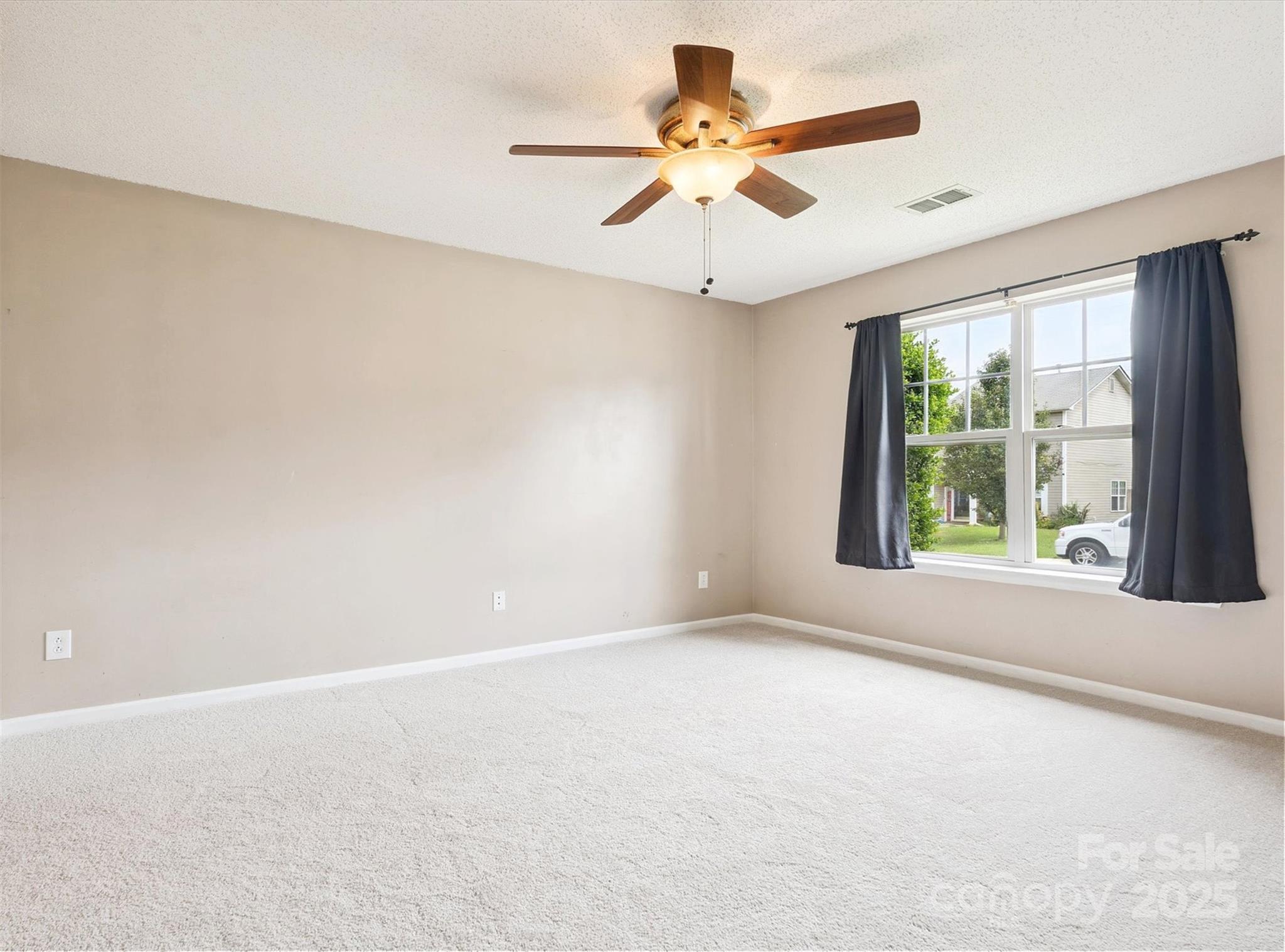 829 Raindrops Road Gastonia, NC 28054 - Photo 5 of 16 en empty room with windows and ceiling fan