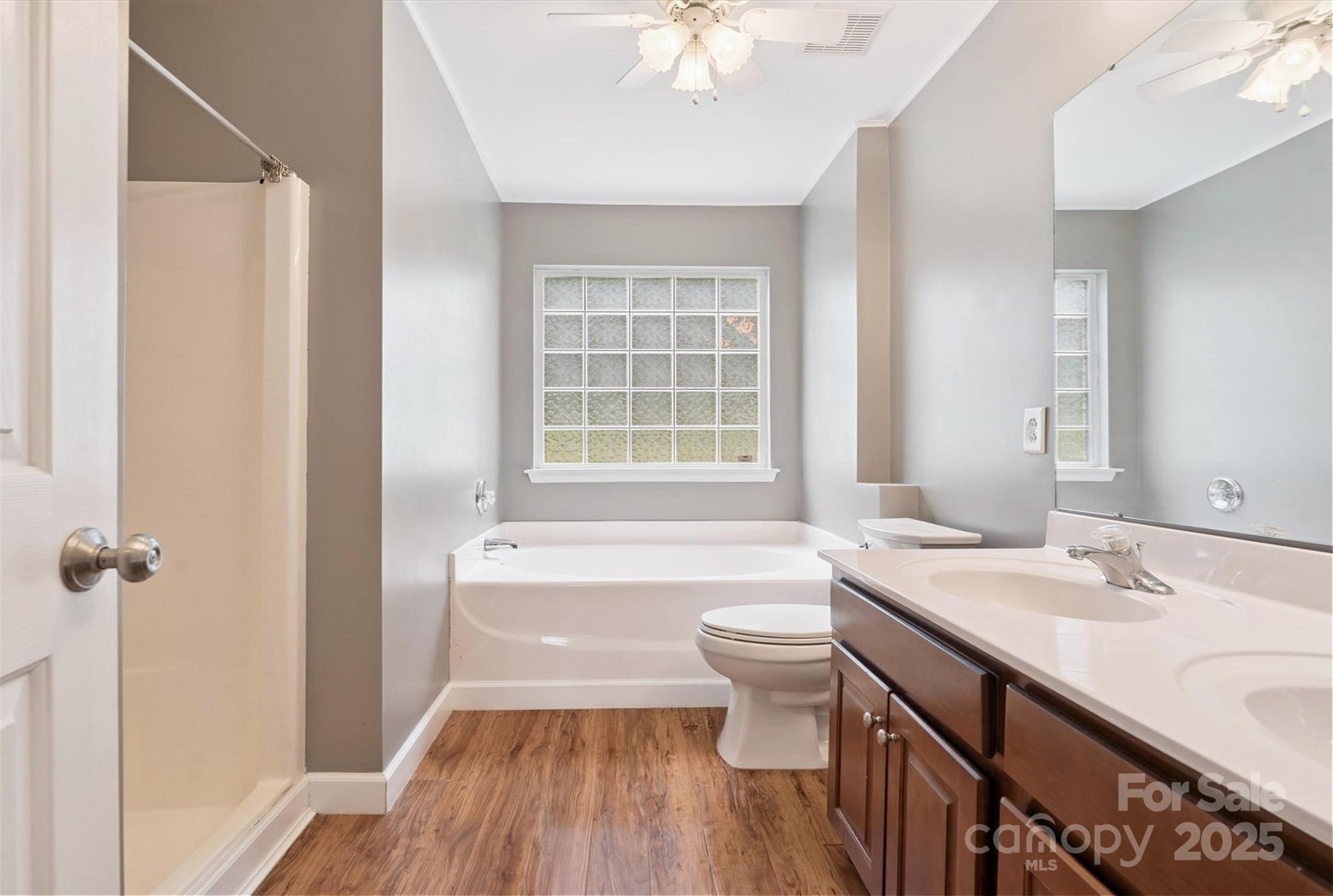 829 Raindrops Road Gastonia, NC 28054 - Photo 7 of 16 a bathroom with a sink a toilet a mirror and bathtub