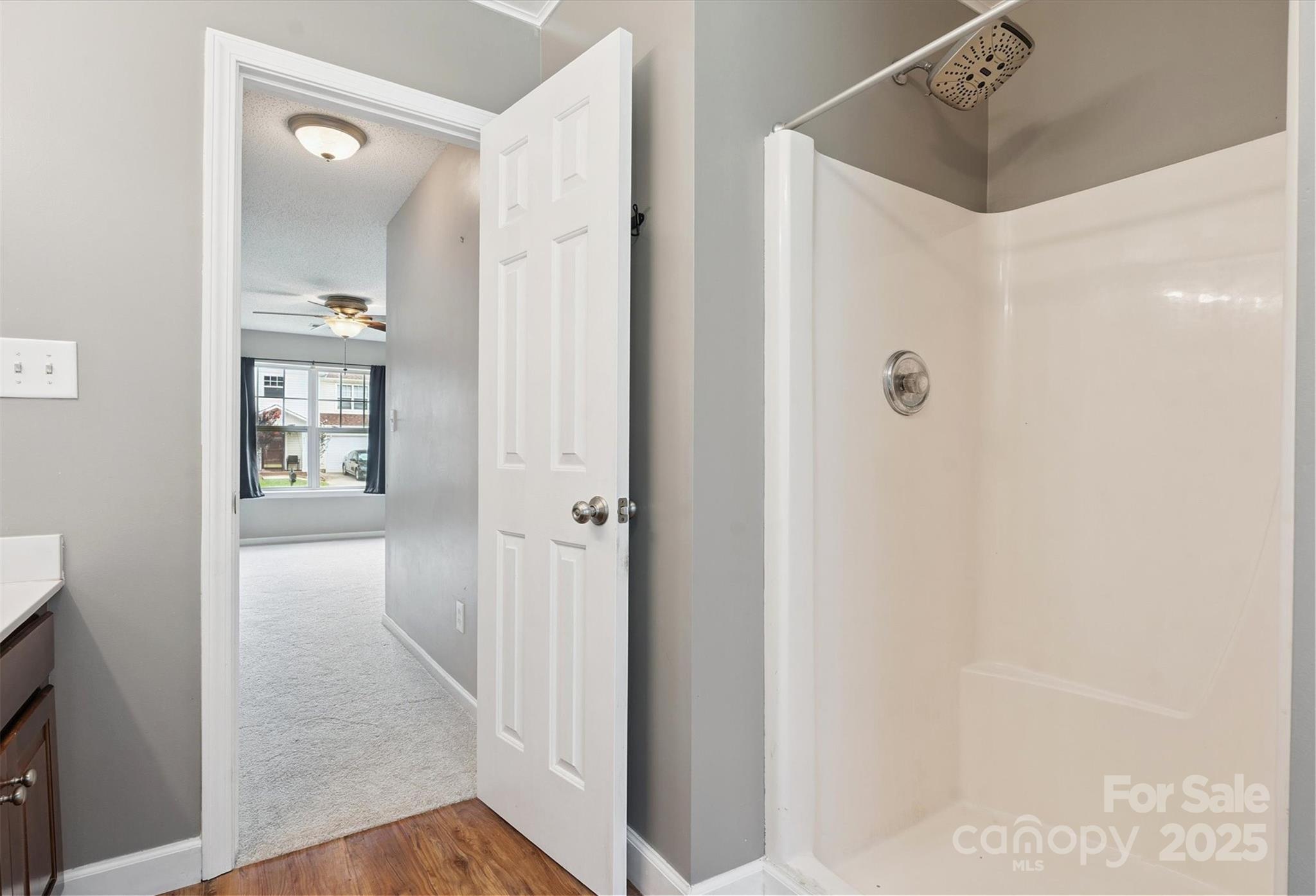 829 Raindrops Road Gastonia, NC 28054 - Photo 8 of 16 a view of a hallway with wooden floor and a bathroom
