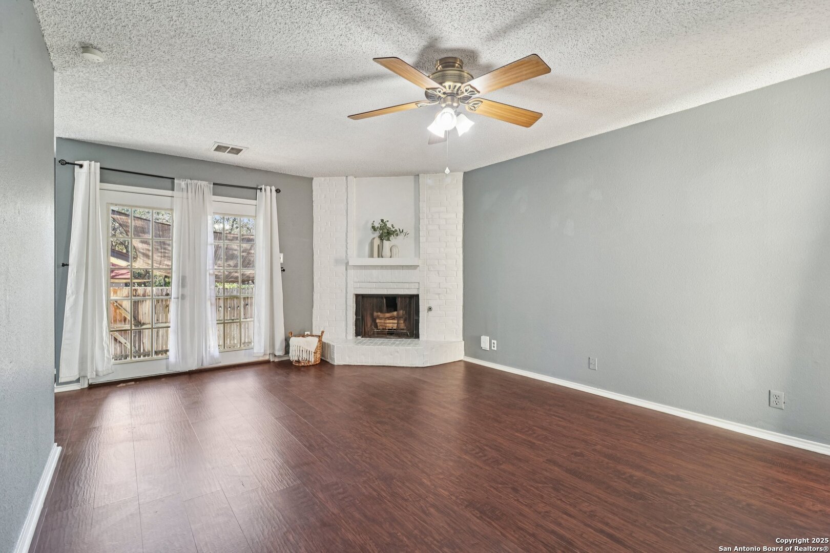 9334 Dover Ridge San Antonio, TX 78250 - Photo 13 of 39 a view of an empty room with wooden floor and a window