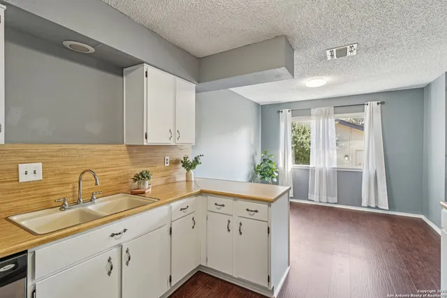 a kitchen with a sink cabinets and window