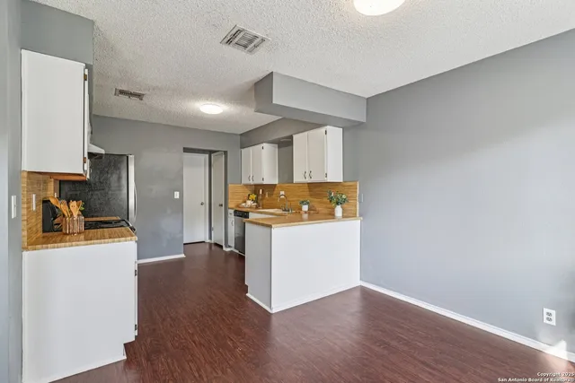 a view of a kitchen with wooden floor
