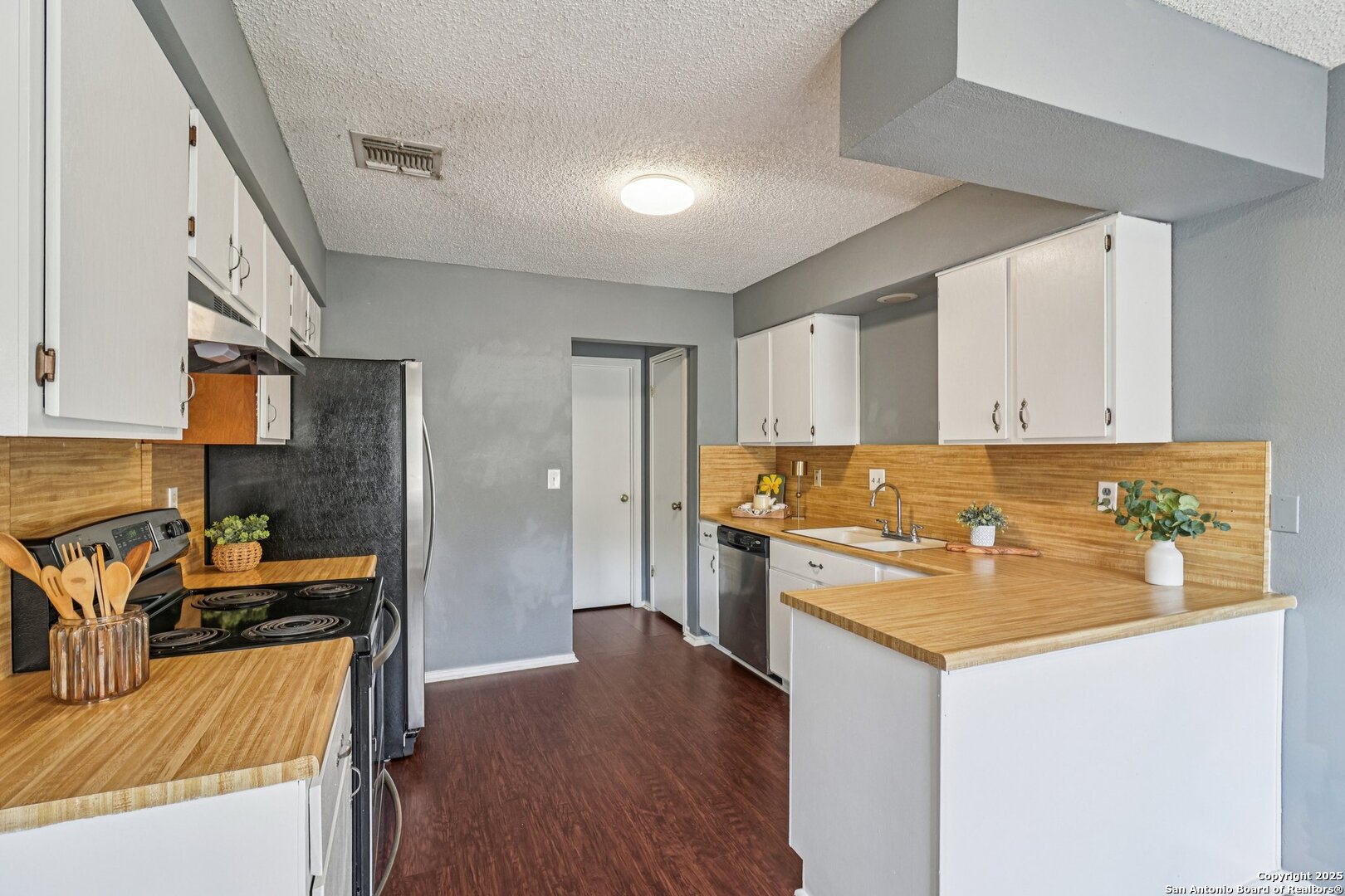 9334 Dover Ridge San Antonio, TX 78250 - Photo 18 of 39 a kitchen with stainless steel appliances granite countertop a sink stove and refrigerator