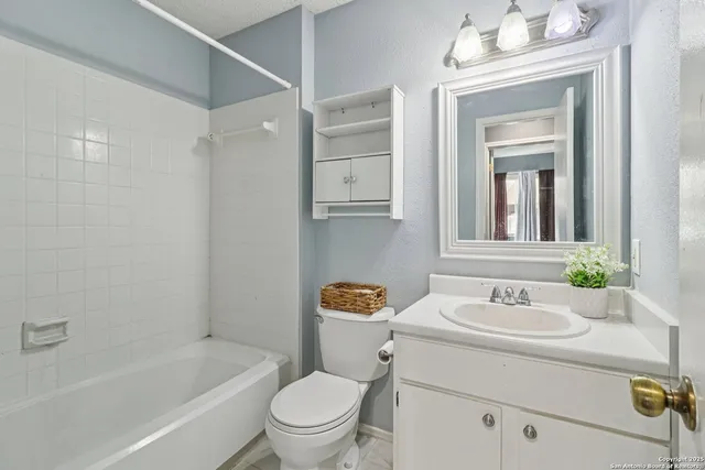 a bathroom with a sink toilet a mirror and shower