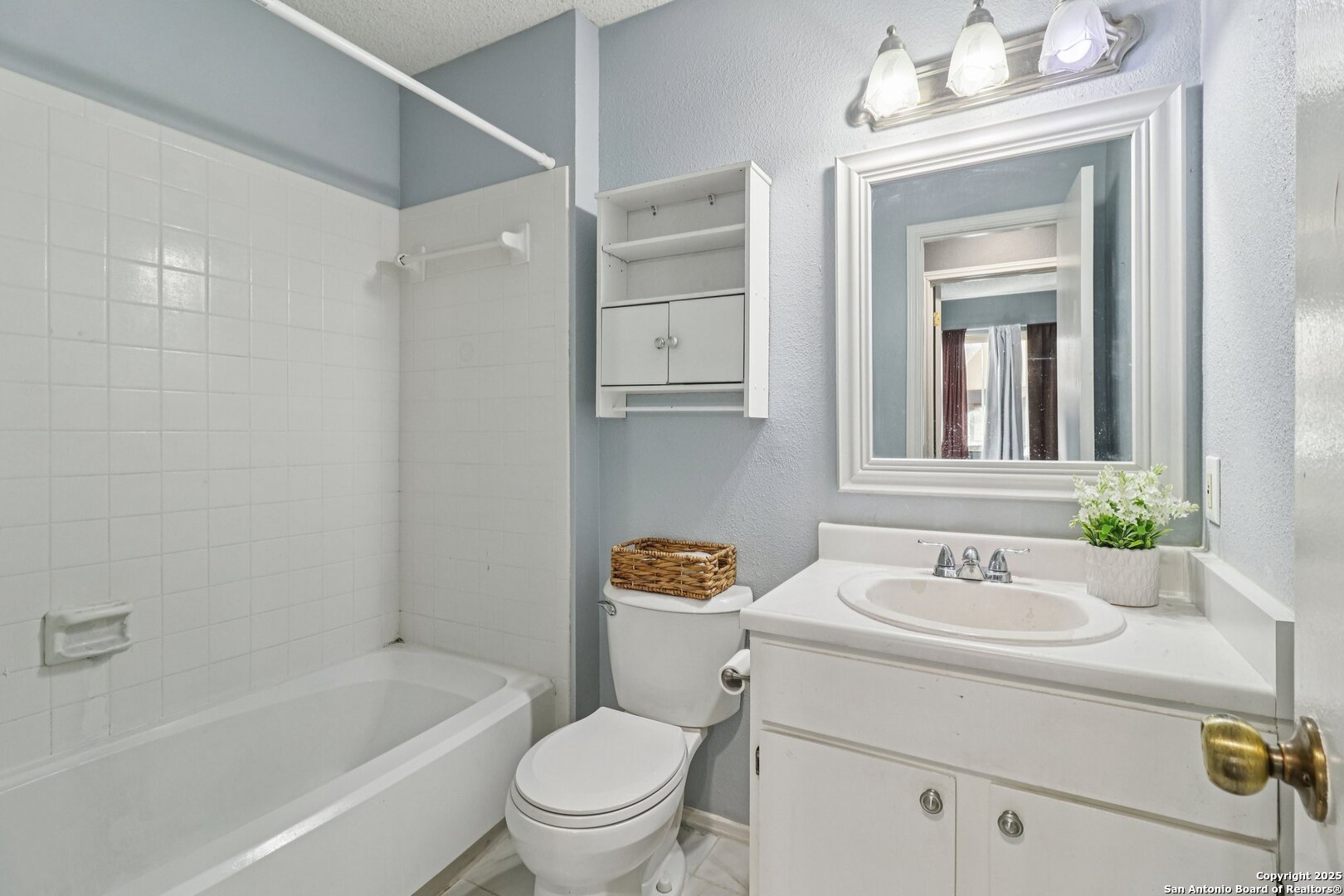 9334 Dover Ridge San Antonio, TX 78250 - Photo 21 of 39 a bathroom with a sink toilet a mirror and shower
