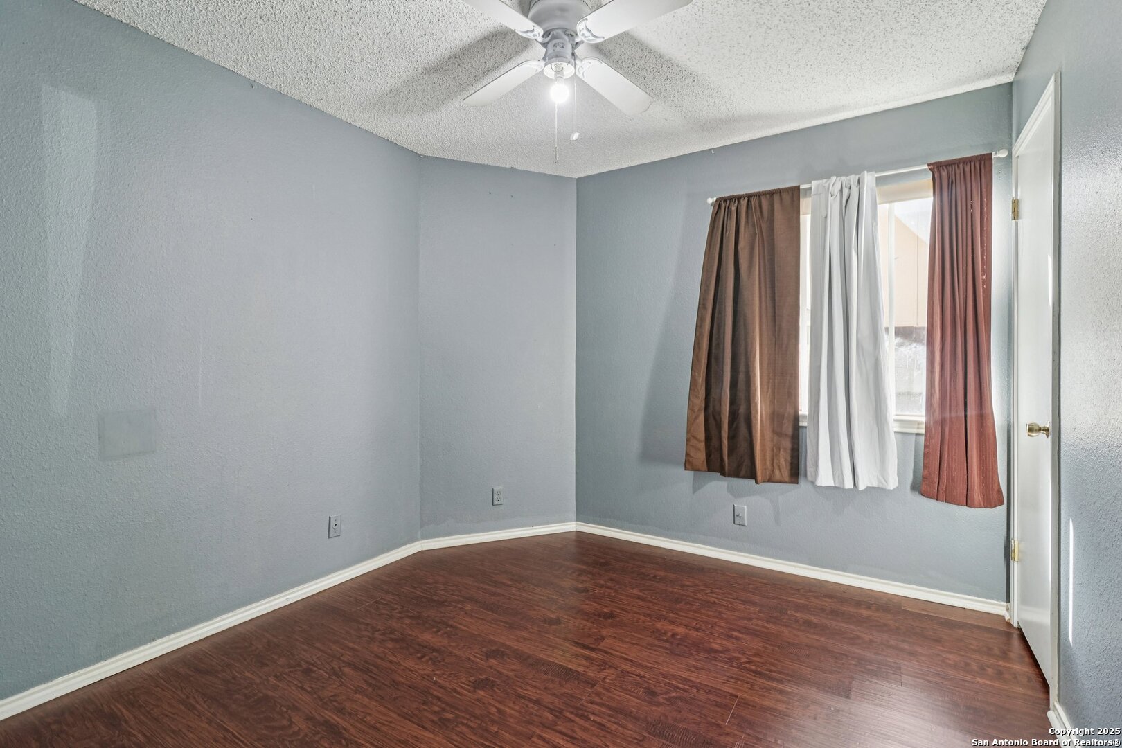9334 Dover Ridge San Antonio, TX 78250 - Photo 23 of 39 an empty room with wooden floor and windows