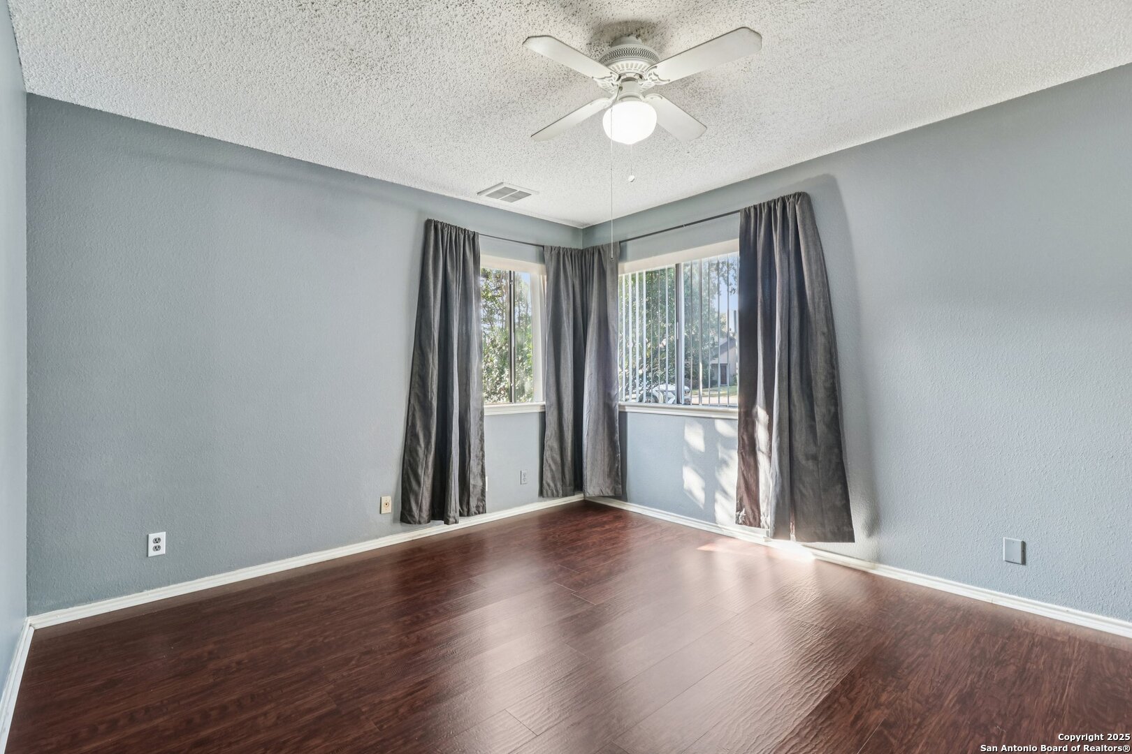 9334 Dover Ridge San Antonio, TX 78250 - Photo 25 of 39 a view of an empty room with wooden floor and a window