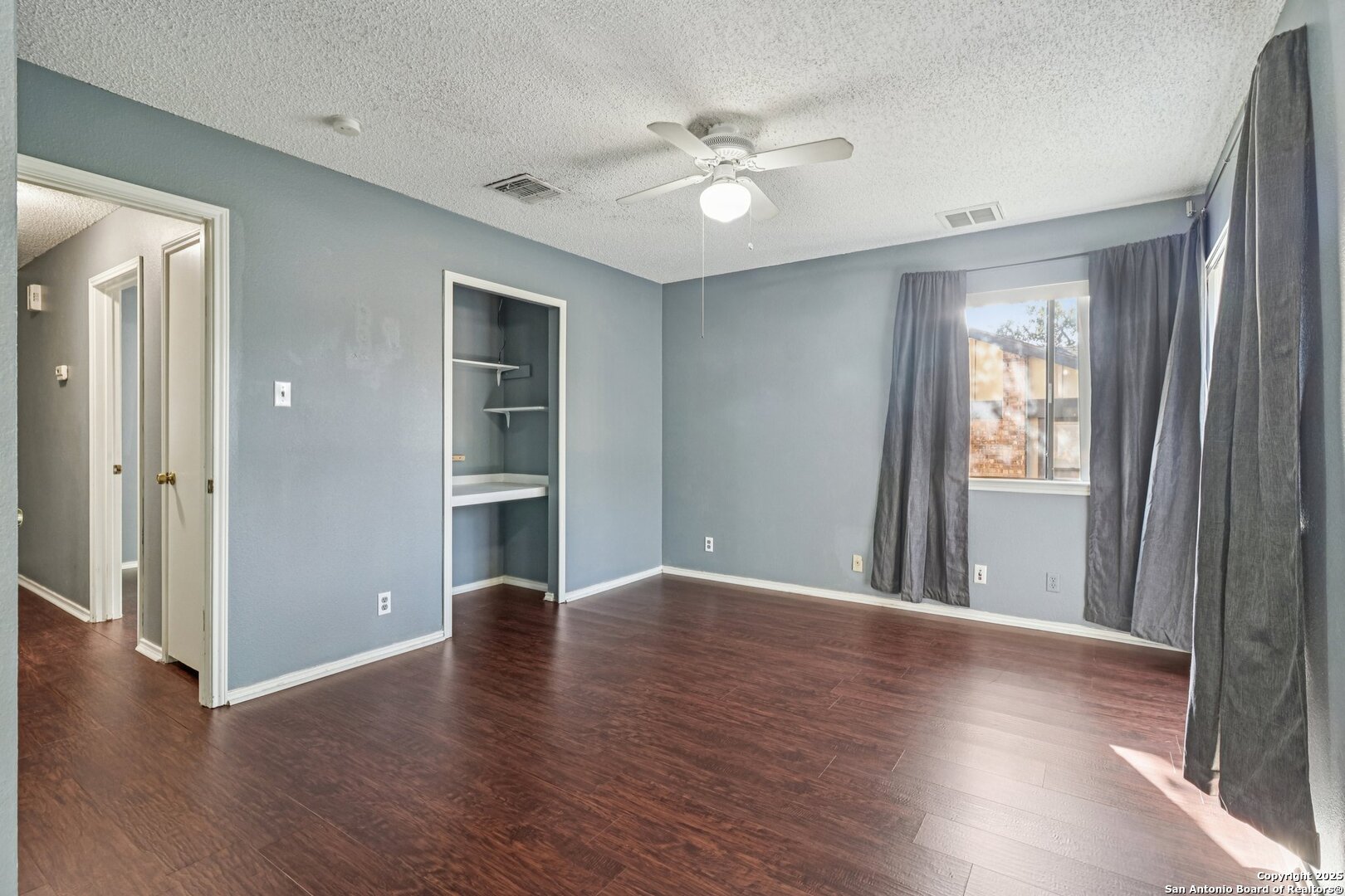 9334 Dover Ridge San Antonio, TX 78250 - Photo 26 of 39 a view of an empty room with wooden floor and a window