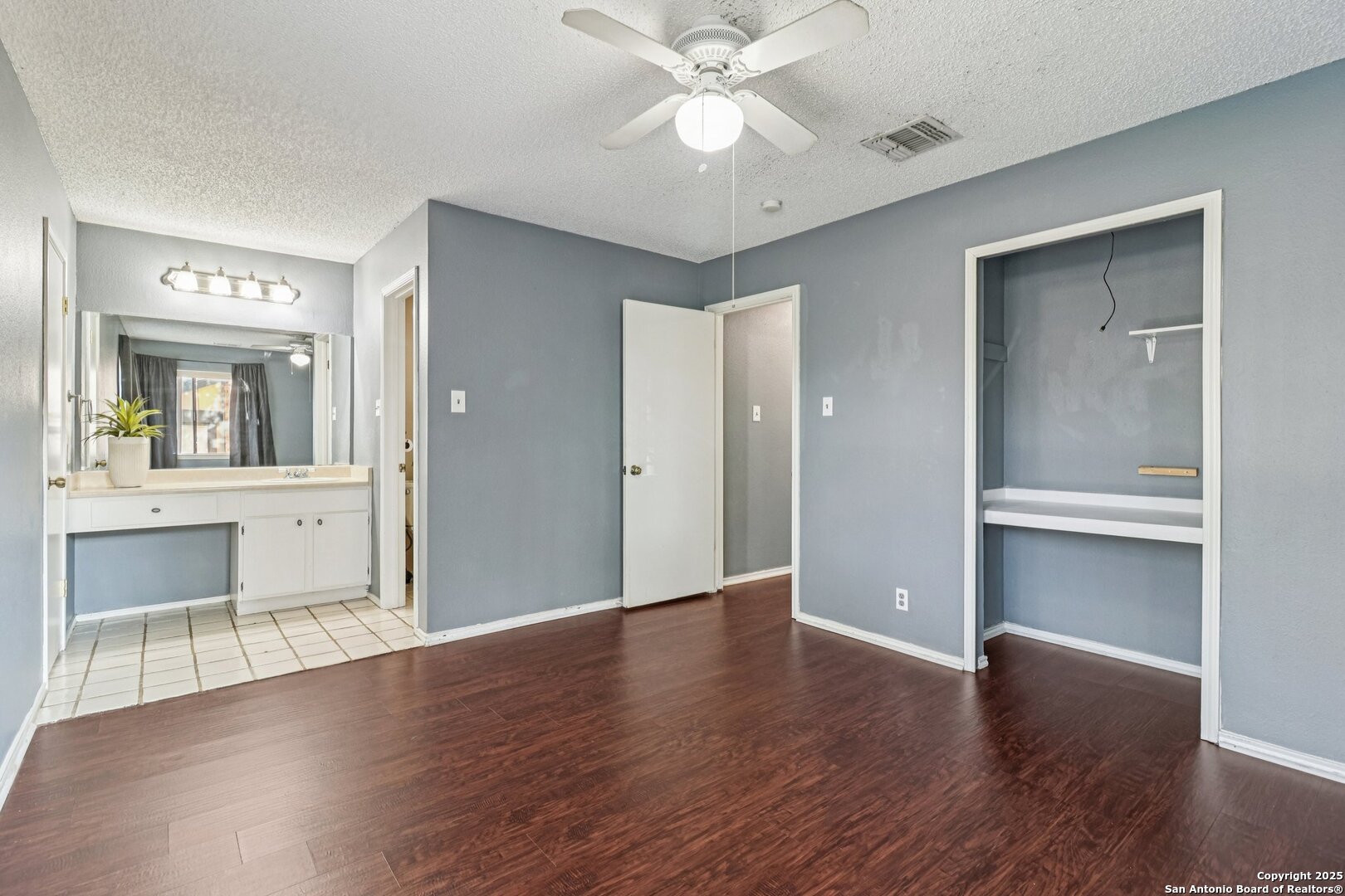 9334 Dover Ridge San Antonio, TX 78250 - Photo 27 of 39 a view of an empty room with a window and wooden floor