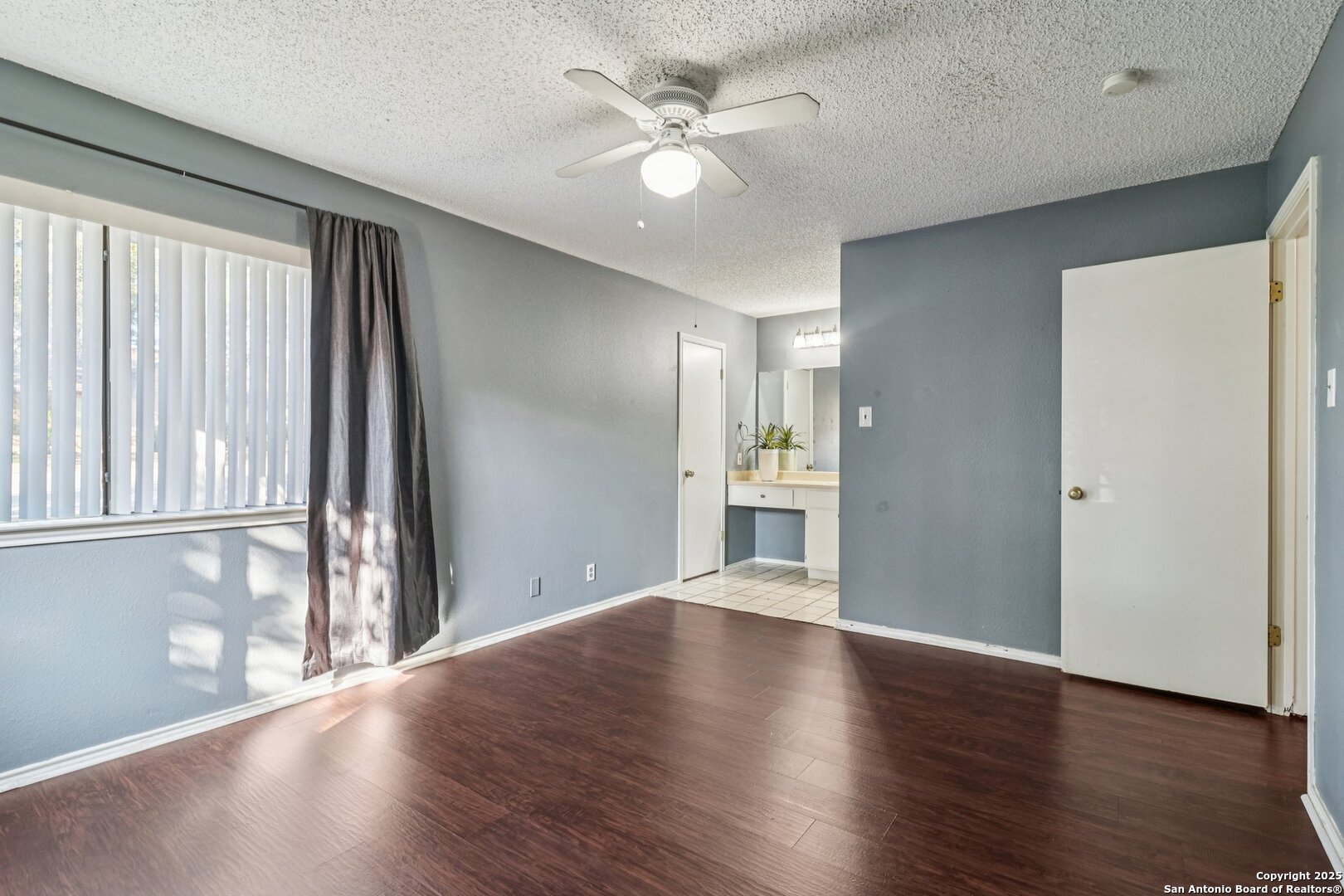 9334 Dover Ridge San Antonio, TX 78250 - Photo 28 of 39 a view of an empty room with wooden floor and a window