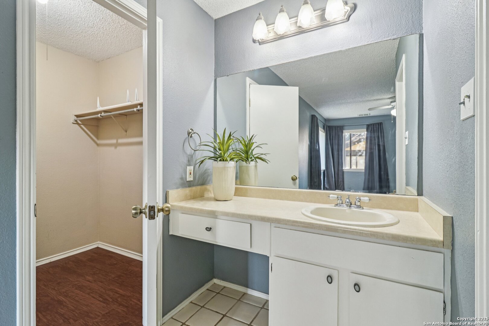 9334 Dover Ridge San Antonio, TX 78250 - Photo 30 of 39 a bathroom with a sink and a mirror