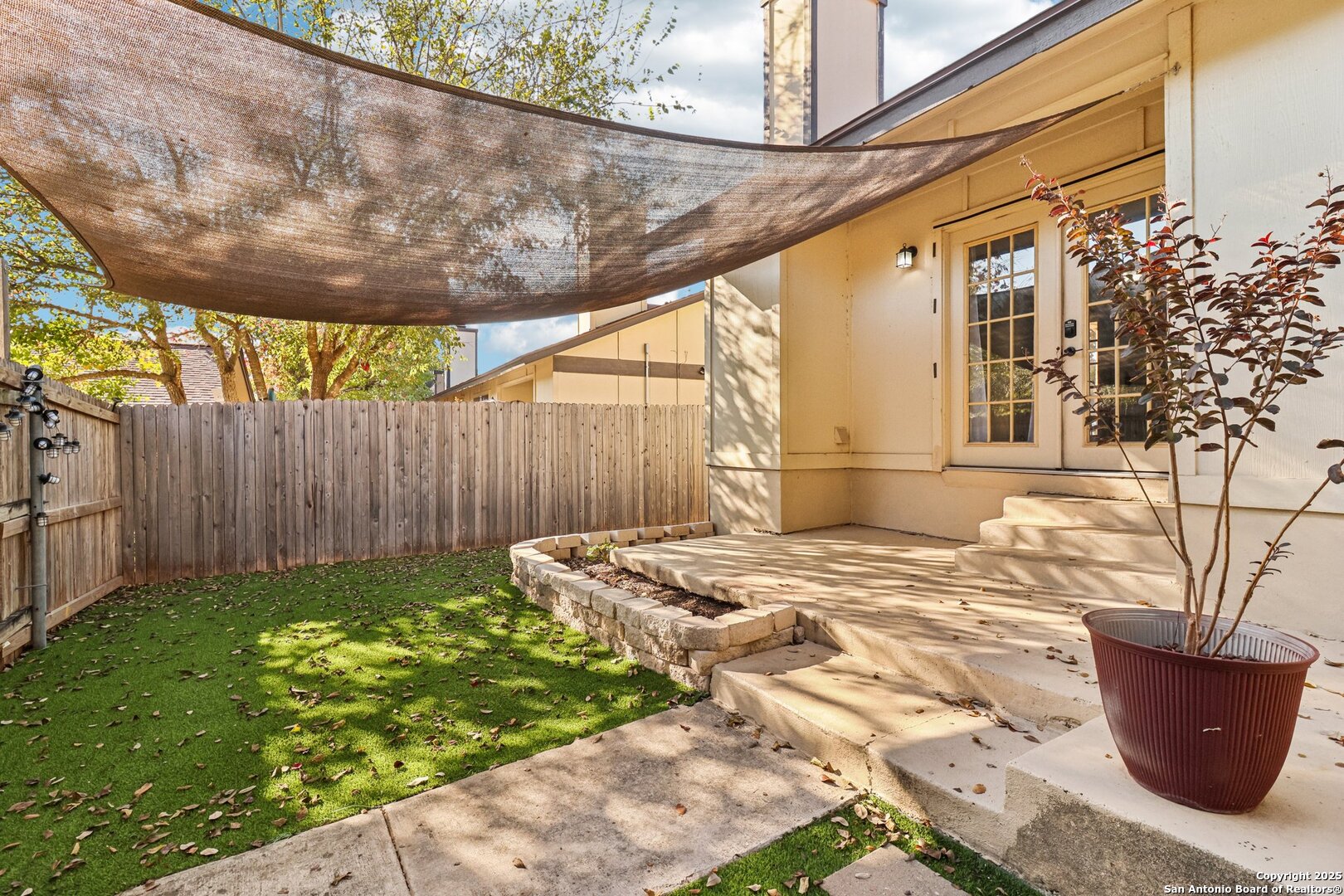 9334 Dover Ridge San Antonio, TX 78250 - Photo 5 of 39 a view of a backyard with table and chairs and wooden fence