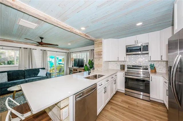 a kitchen with sink cabinets and stainless steel appliances