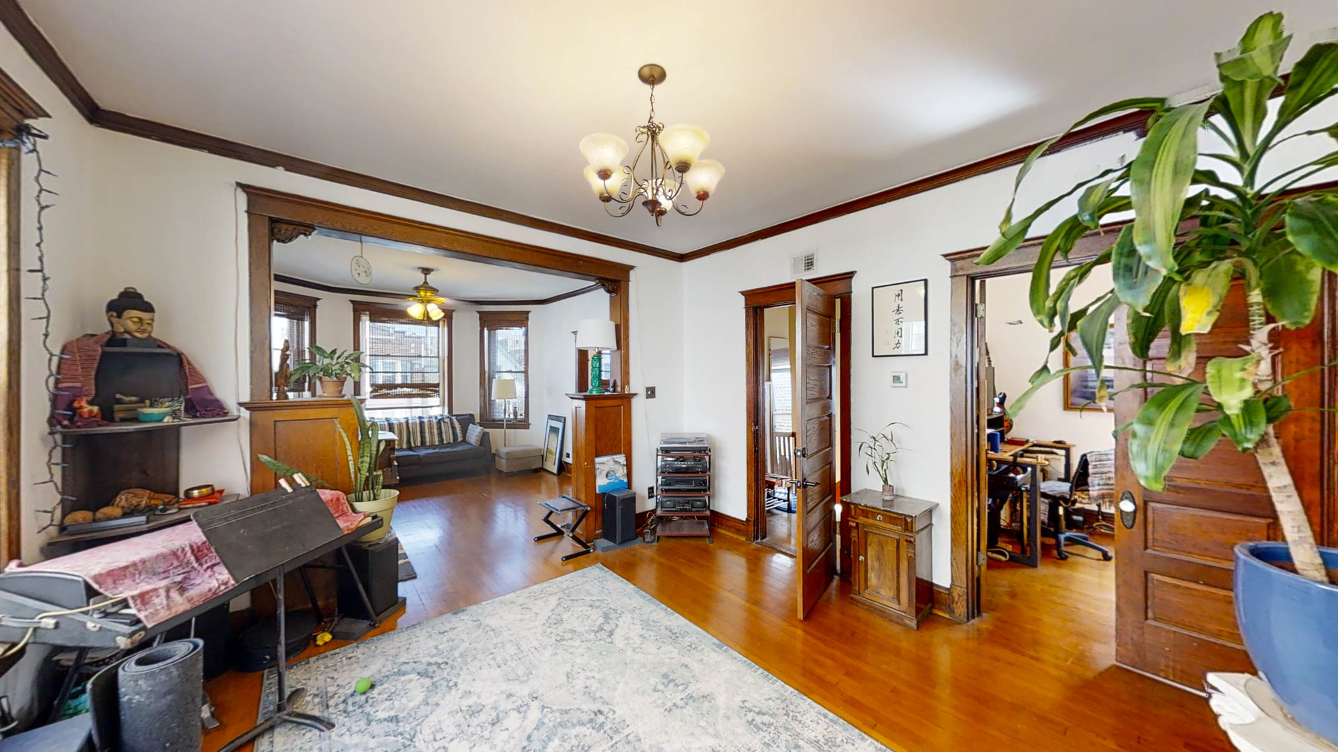 3237 West Cortez Street Chicago, IL 60651 - Photo 14 of 28 a living room filled with furniture and a chandelier