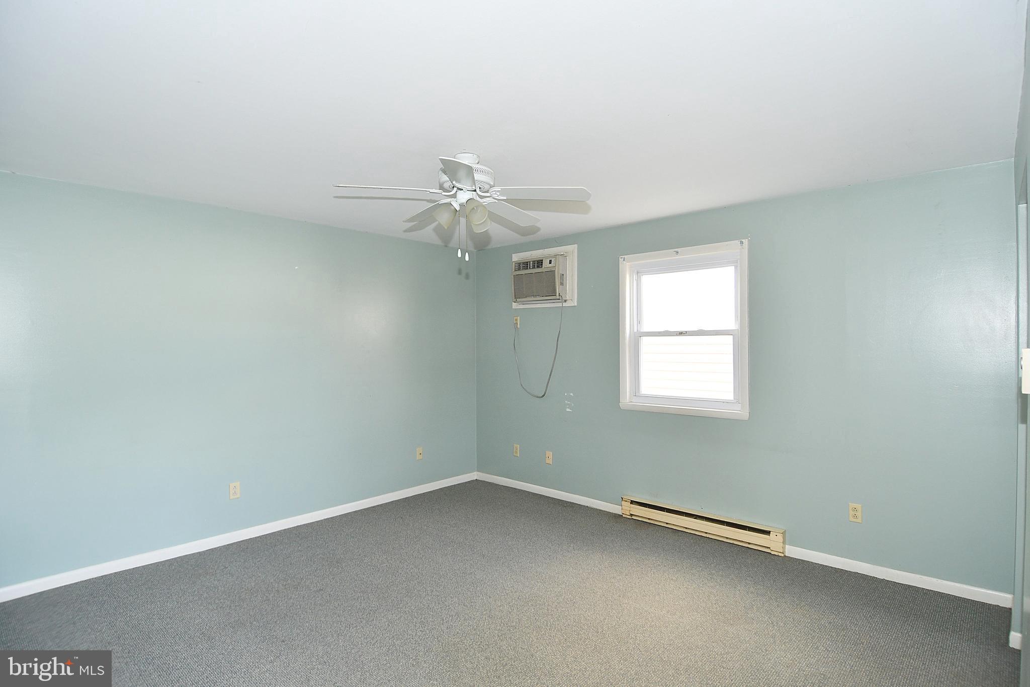 168 North Washington Street, Unit 101 Berkeley Springs, WV 25411 - Photo 1 of 8 an empty room with a window