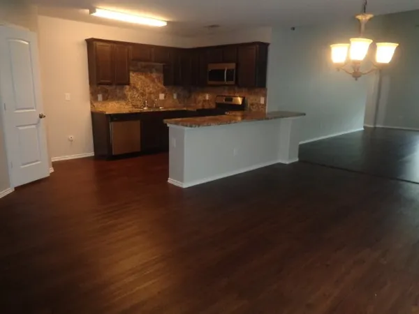 a kitchen with stainless steel appliances granite countertop a sink and a stove