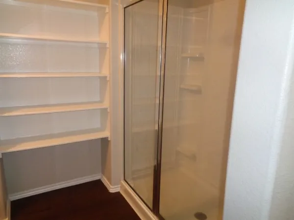 a view of walk in closet with empty racks
