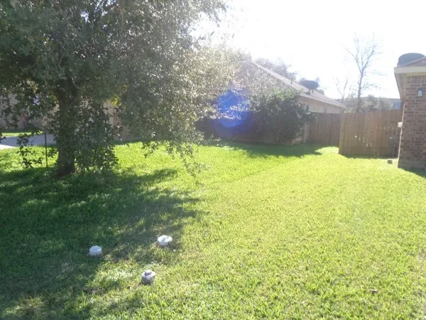 a backyard of a house with lots of green space