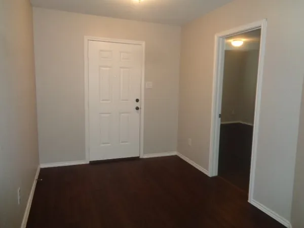 an empty room with wooden floor