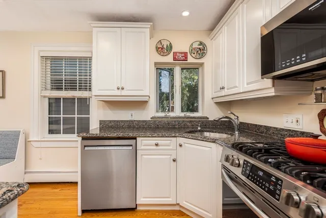 a kitchen with granite countertop a stove and a sink