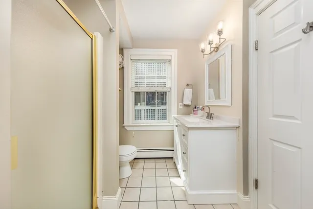 a bathroom with a granite countertop sink a toilet and a mirror