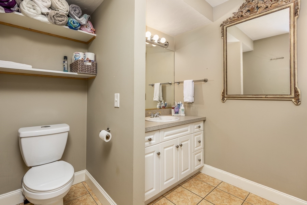 10 Andrew Street, Unit 2A Salem, MA 01970 - Photo 15 of 27 a bathroom with a toilet sink and mirror