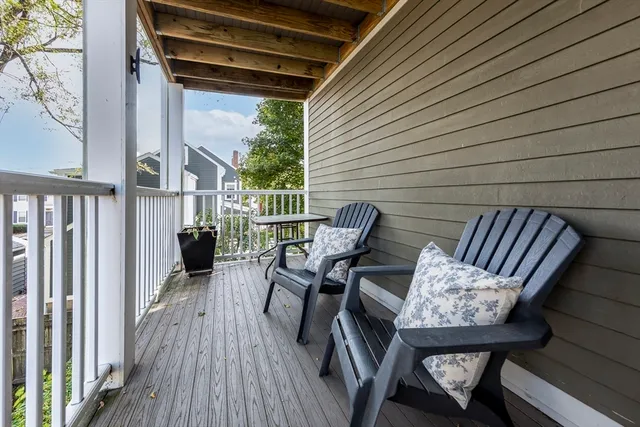 a view of balcony with wooden floor and outdoor seating