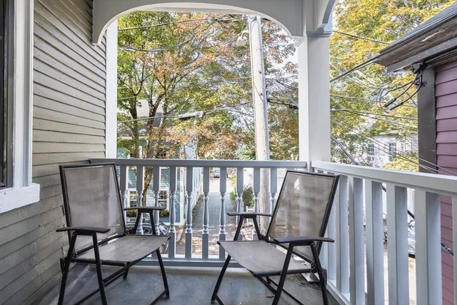 a view of a chair and table in wooden floor