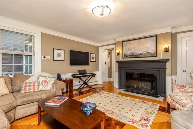 a living room with furniture a flat screen tv and a fireplace