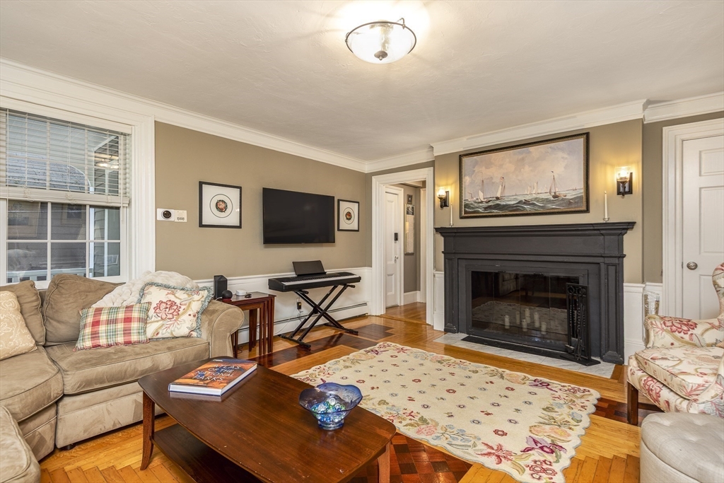 10 Andrew Street, Unit 2A Salem, MA 01970 - Photo 4 of 27 a living room with furniture a flat screen tv and a fireplace