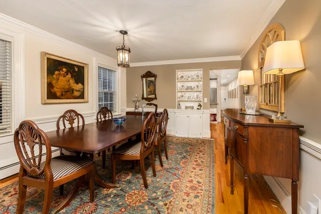 a view of a a dining room with furniture window and wooden floor